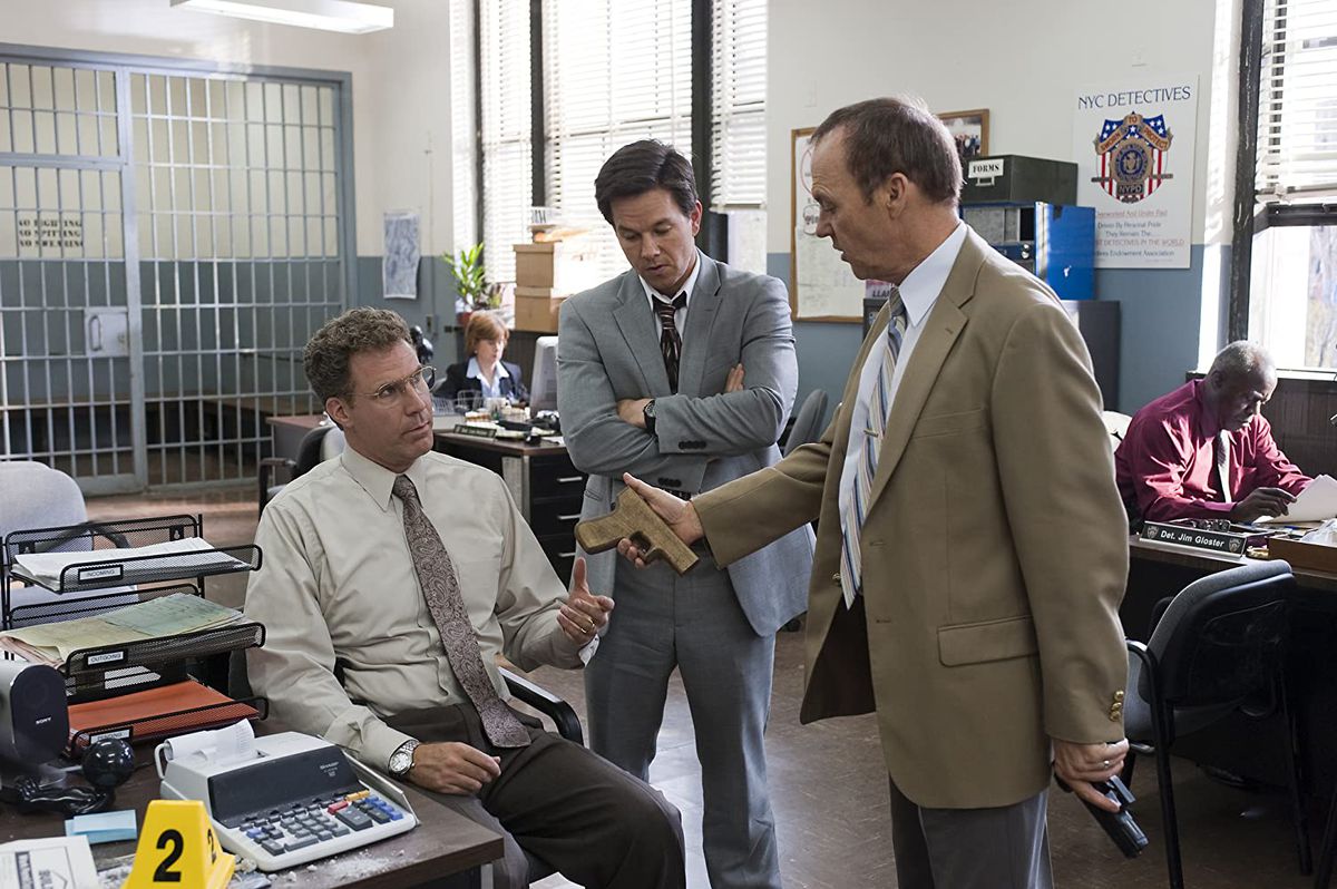 Will Ferrell (seduto) Mark Walberg e Michael Keaton in uno screenshot da The Other Guys