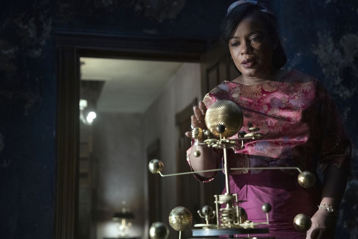 Aunjanue Ellis as Hippolyta Freeman, approaching an orrery in an old house, in Lovecraft Country.