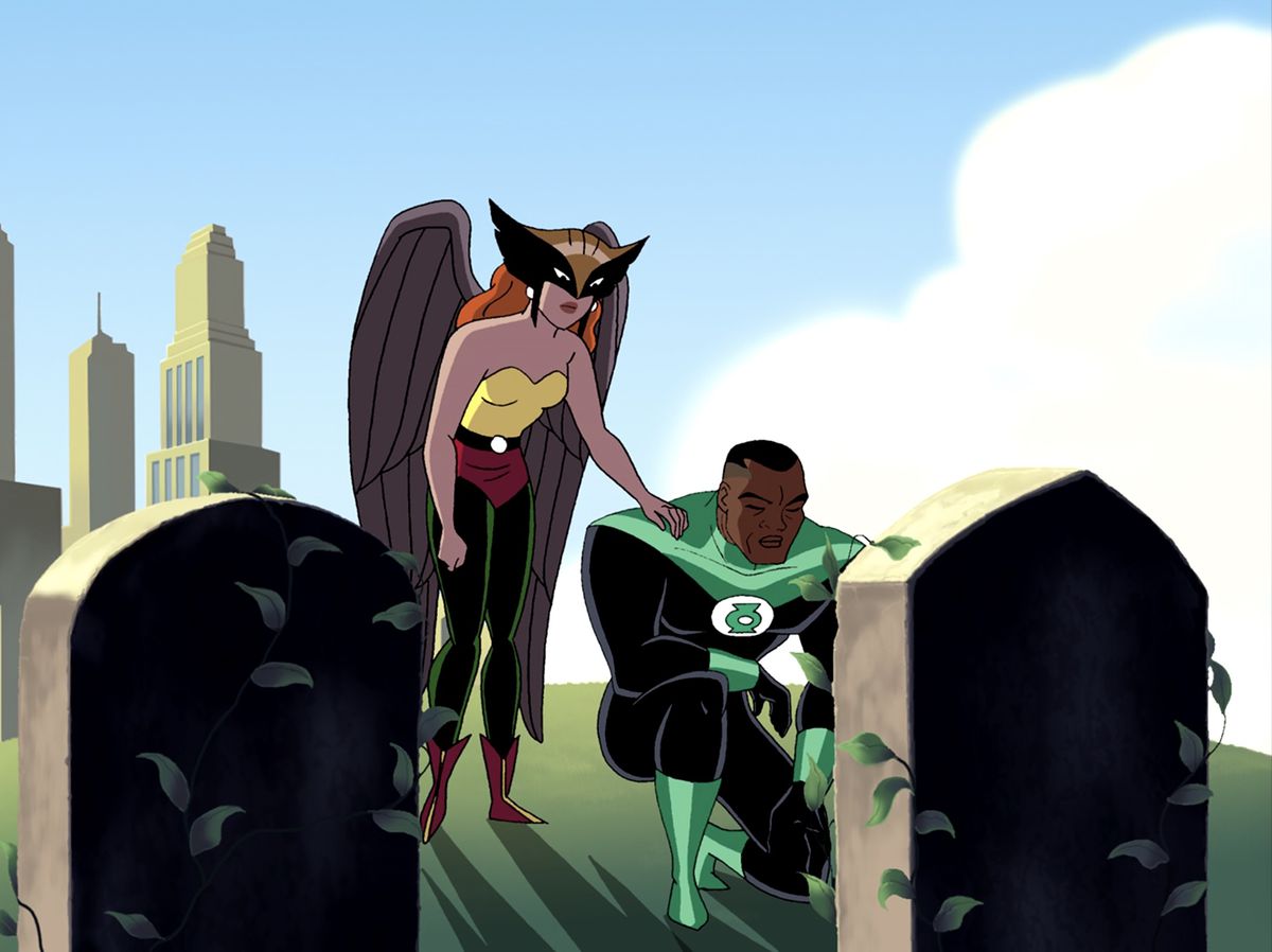 Lanterna Verde John Stewart si inginocchia su una tomba mentre Hawkgirl lo consola
