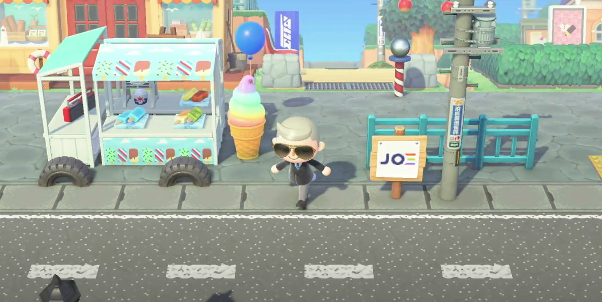 screenshot of Joe Biden’s Animal Crossing avatar on a streetscape including an ice cream truck and campaign signs