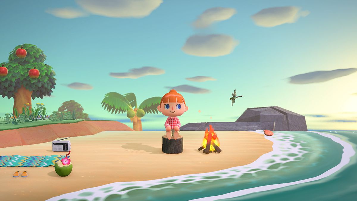 A human sitting on the beach wearing a red shirt in Animal Crossing: New Horizons