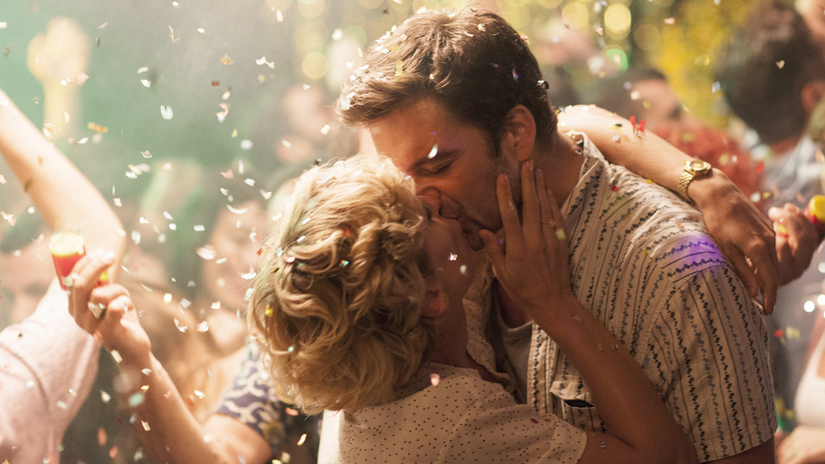 Sebastian Stan and Denise Gough embrace amid a shower of confetti in the romantic drama Monday