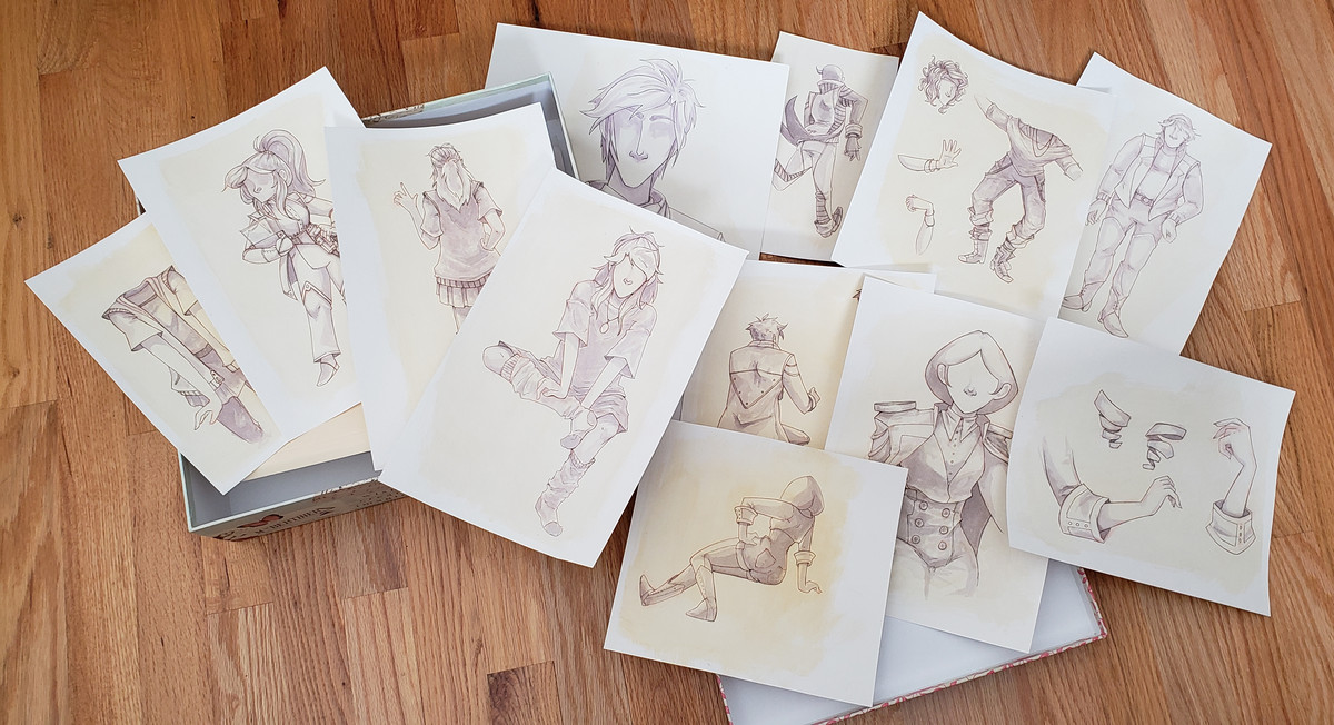 a bunch of watercolor paintings spread out on the floor