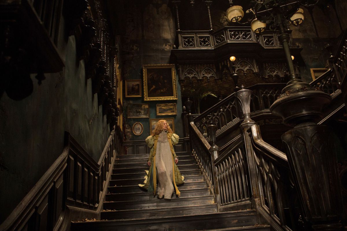 a lone figure in white walking down the staircase of a dilapidated mansion