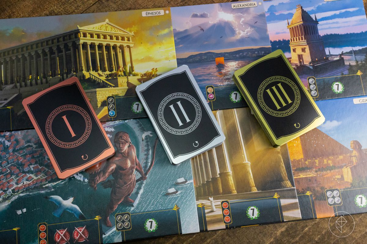 The decks for the three ages of 7 Wonders layed out on the sideboard cards representing each of the game’s wonders.