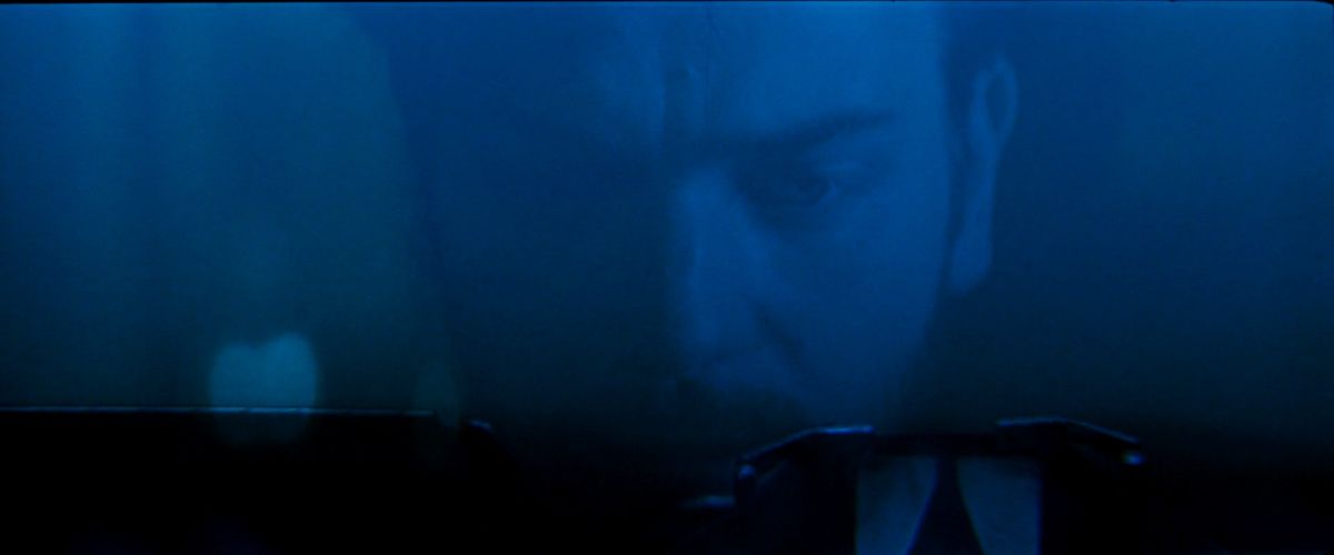 Ewan McGregor, in dim blue light, hunches over a typewriter in Moulin Rouge
