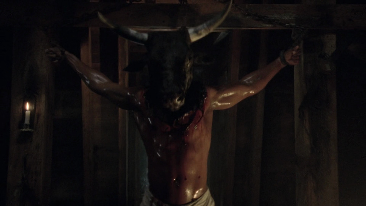 a buff man with a bull’s head sewn onto him