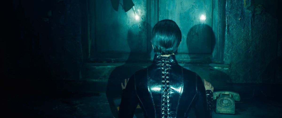 Trinity sits at the phone