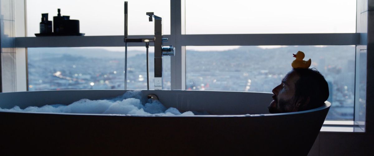neo in a bathtub with a duck on his head in The Matrix Resurrections