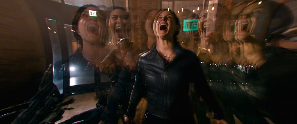 Trinity plus another person phasing in and out of reality in The Matrix Resurrections