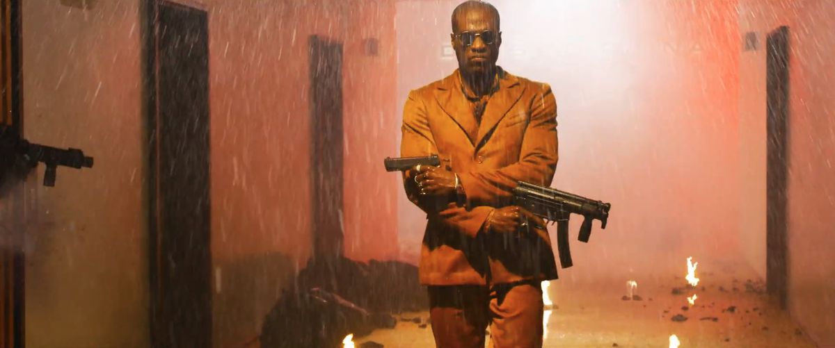 yahya abdul-mateen ii as young morpheus-ish guy firing guns in a hallway in The Matrix Revolutions