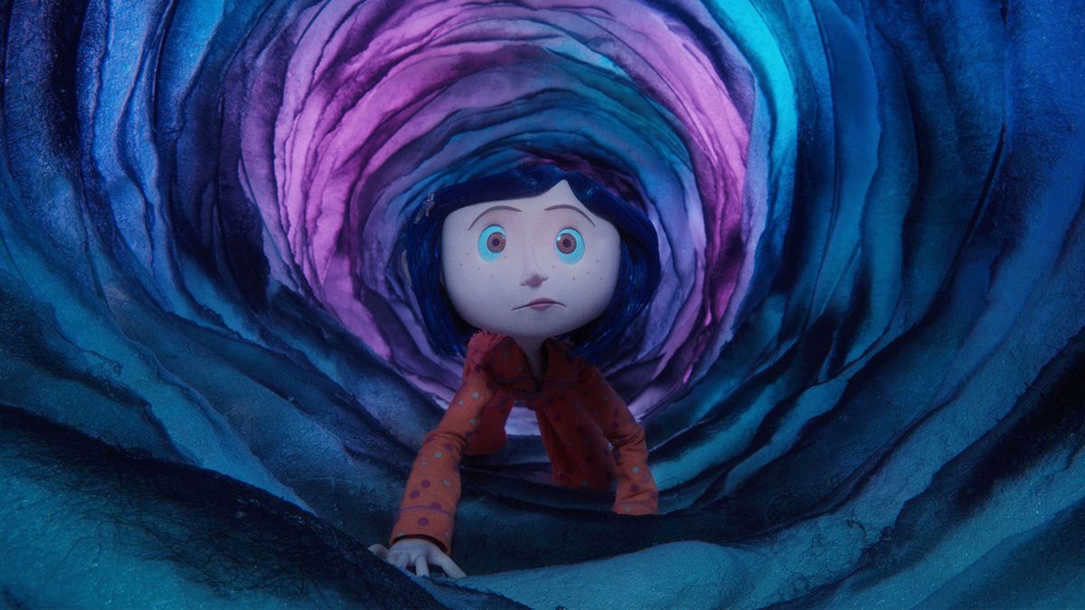 Coraline crawls through an otherworldly tunnel.
