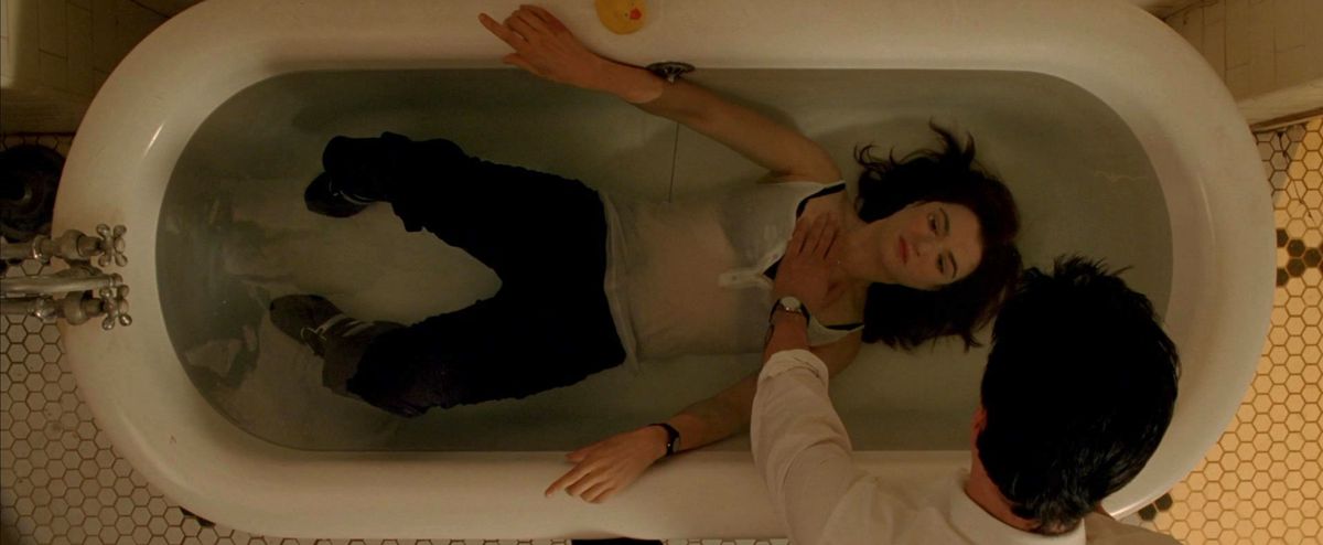 constantine holds angela under water in a bathtub