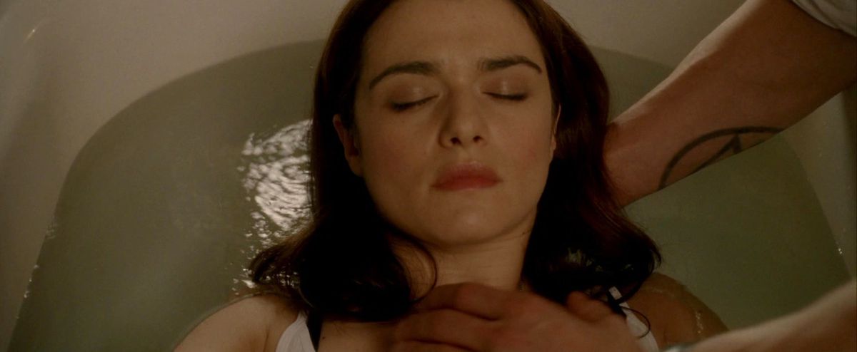 constantine lays angela under water in a bathtub