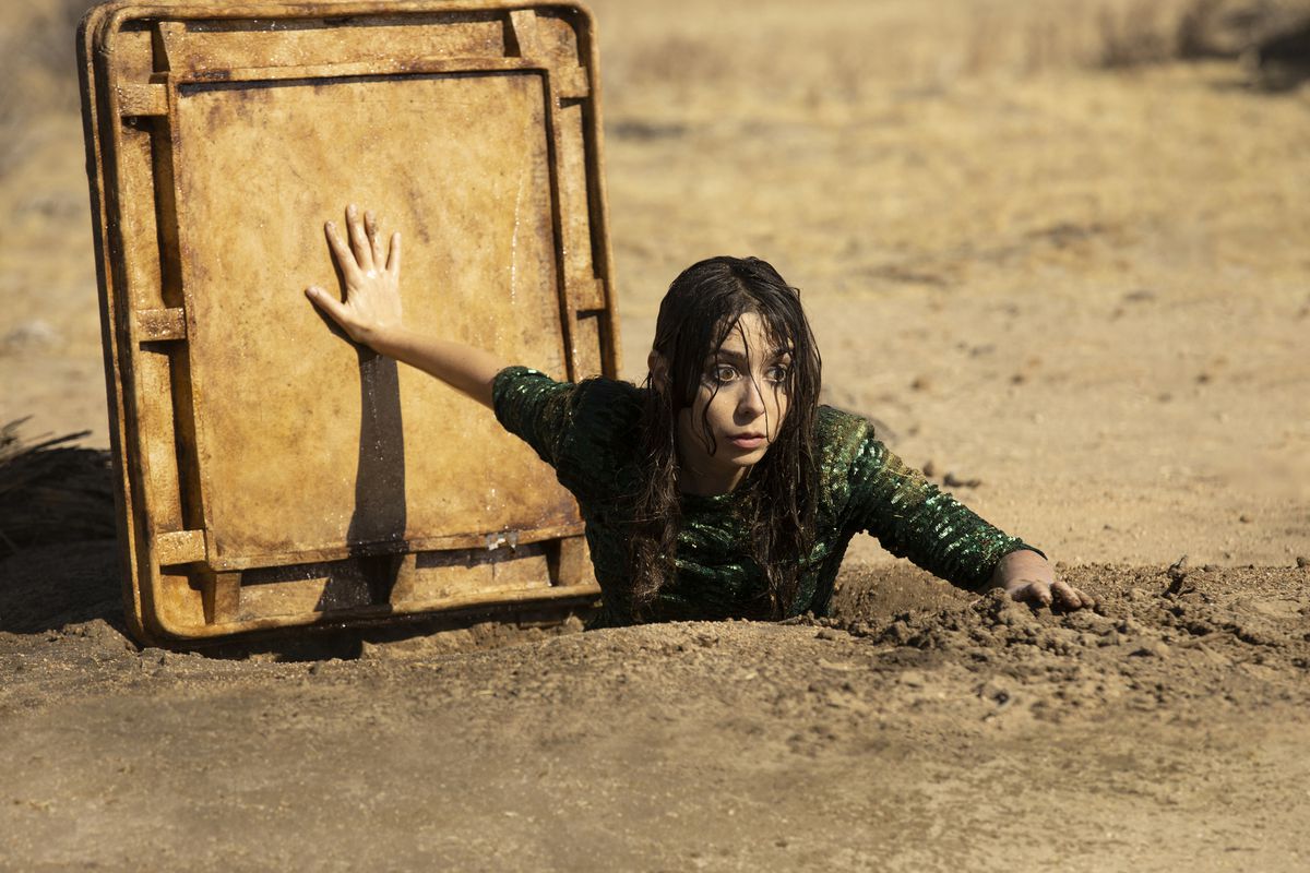 Cristin Milioti as Hazel Green emerges from a sewage pipe in the desert.