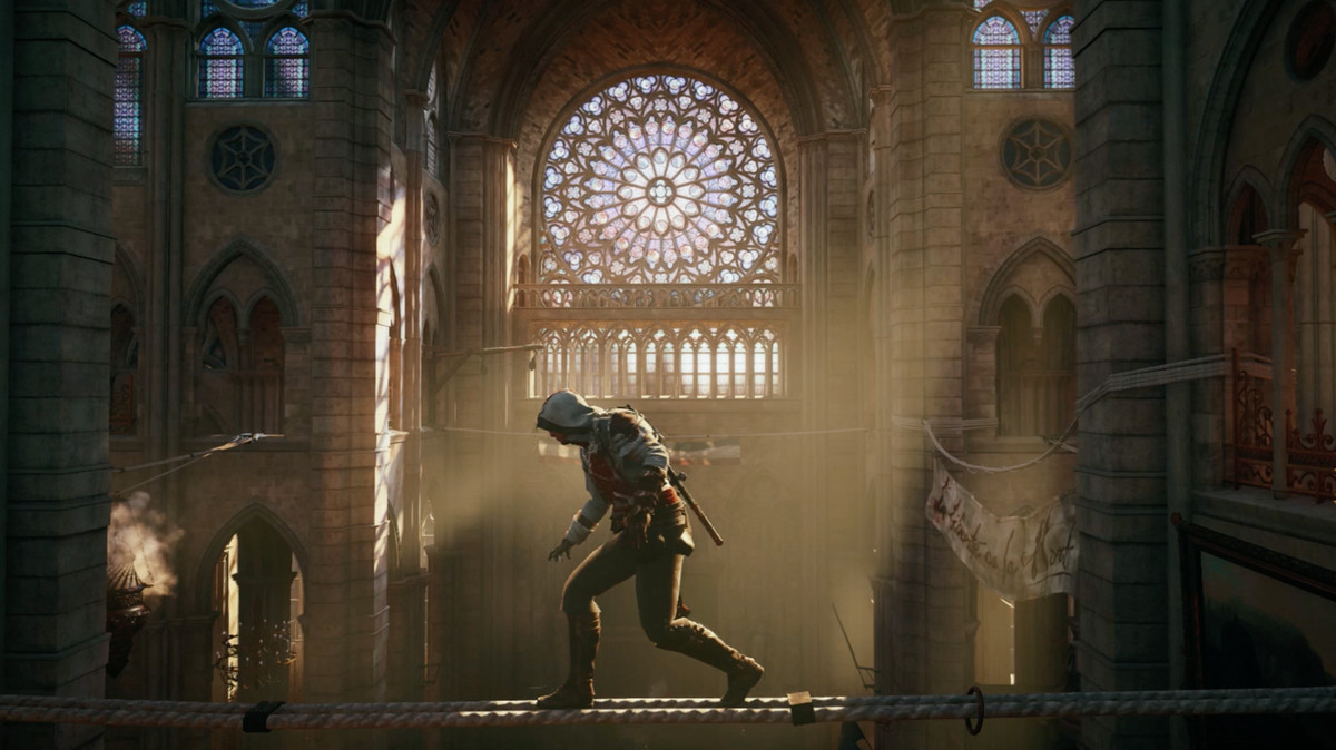 Arno crossing the transept on a cable, with the northern rose window of Notre-Dame visible across the cathedral behind him, in Assassin’s Creed Unity