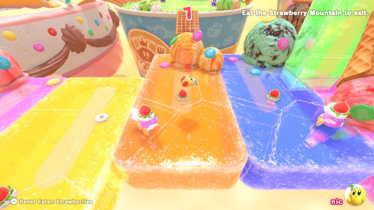Kirby vola in aria su una pista da corsa a base di gelatina.