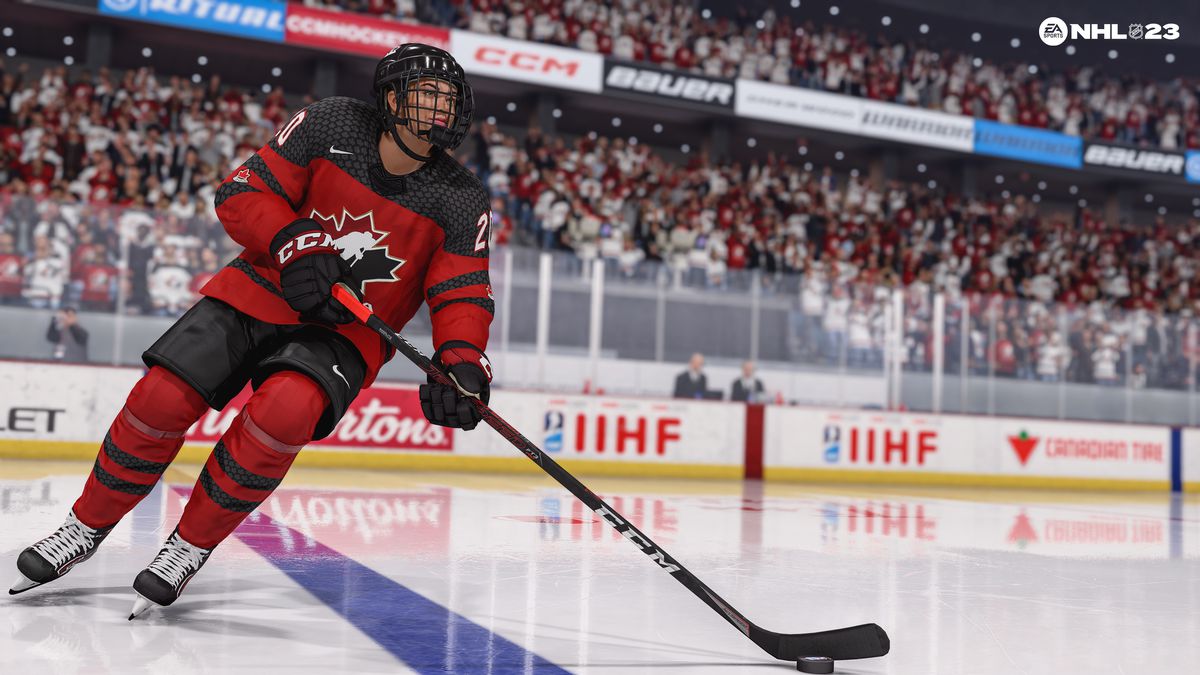 uno screenshot di Sarah Nurse, n. 20, che pattina con il disco indossando la maglia casalinga rossonera della nazionale femminile canadese in NHL 23
