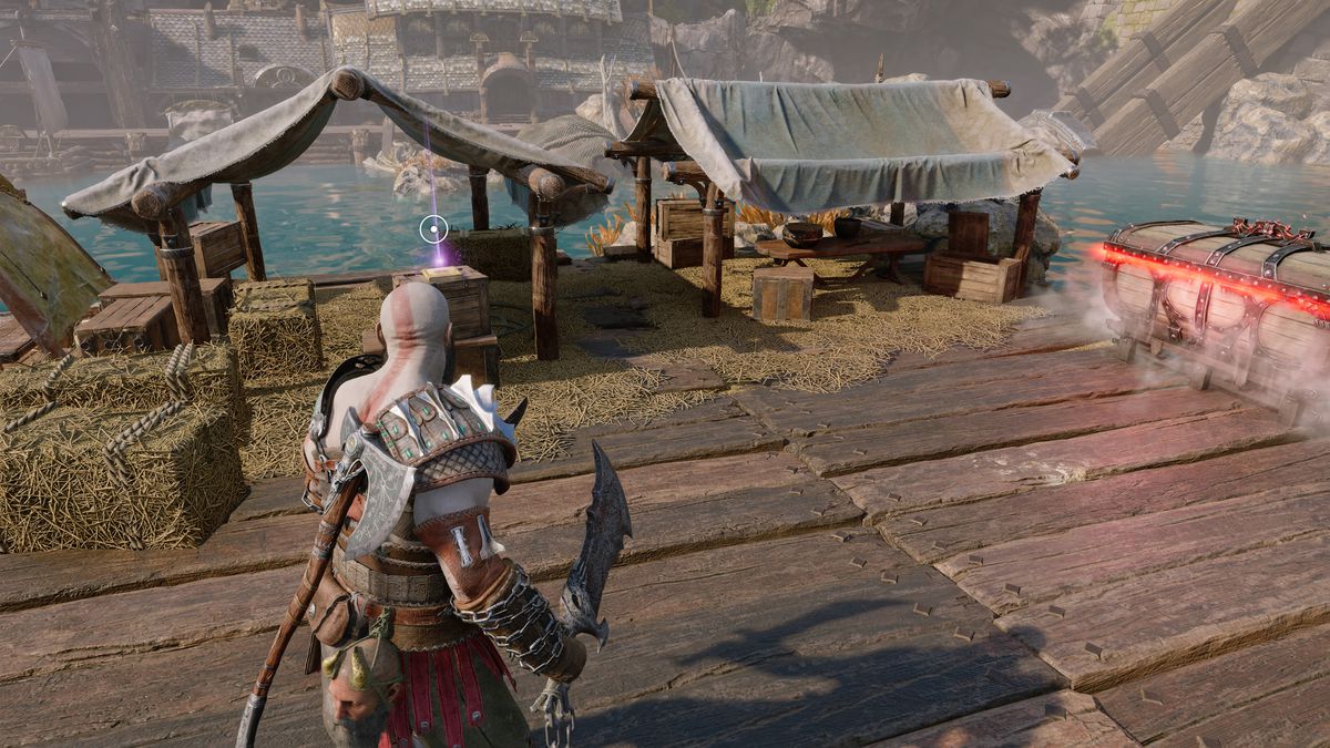 Kratos prende un libro in God of War Ragnarök