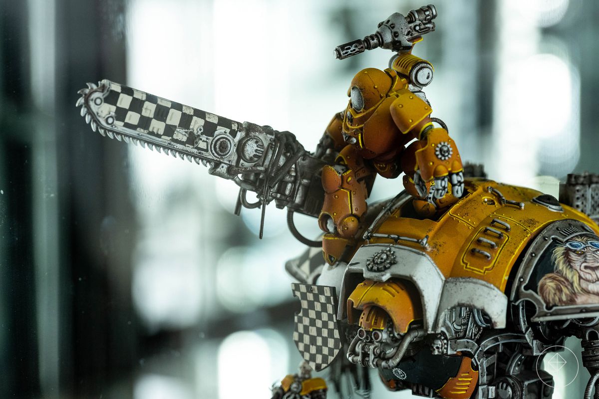 A robot steps from the cockpit of another robot. Both are yellow, with black and white checked accents. Both miniatures are remarkable for their smooth texture and even gradient — a challenge especially with yellow tones.