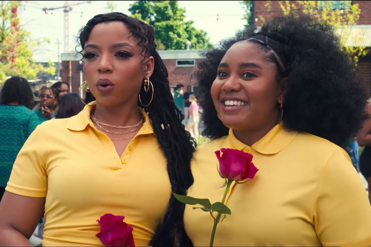 Chloe Bailey e Anjelika Washington tengono in mano rose e indossano camicie dal colletto giallo in Praise This.