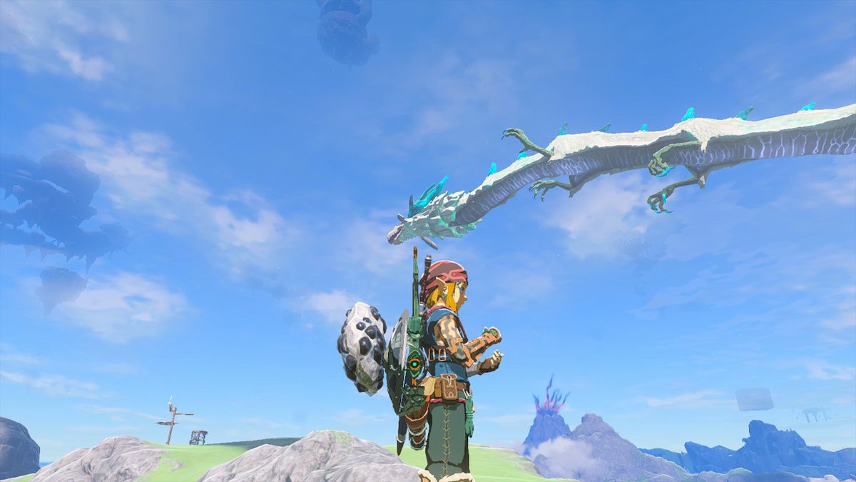 Naydra il drago vola nel cielo mentre Link resta a terra durante una giornata di sole in Zelda Tears of the Kingdom.