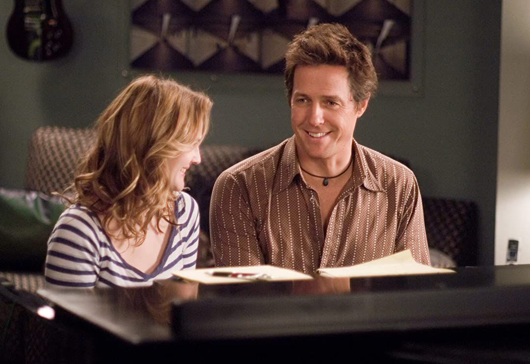musica e testi: hugh grant e Drew Barrymore si siedono al piano e sorridono