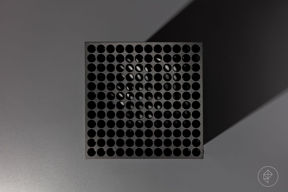 close-up of the vent on an Xbox Series X video game console photographed on a dark gray background
