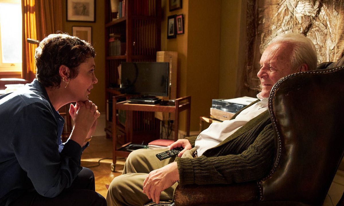 Olivia Colman and Anthony Hopkins sit in a living room in The Father