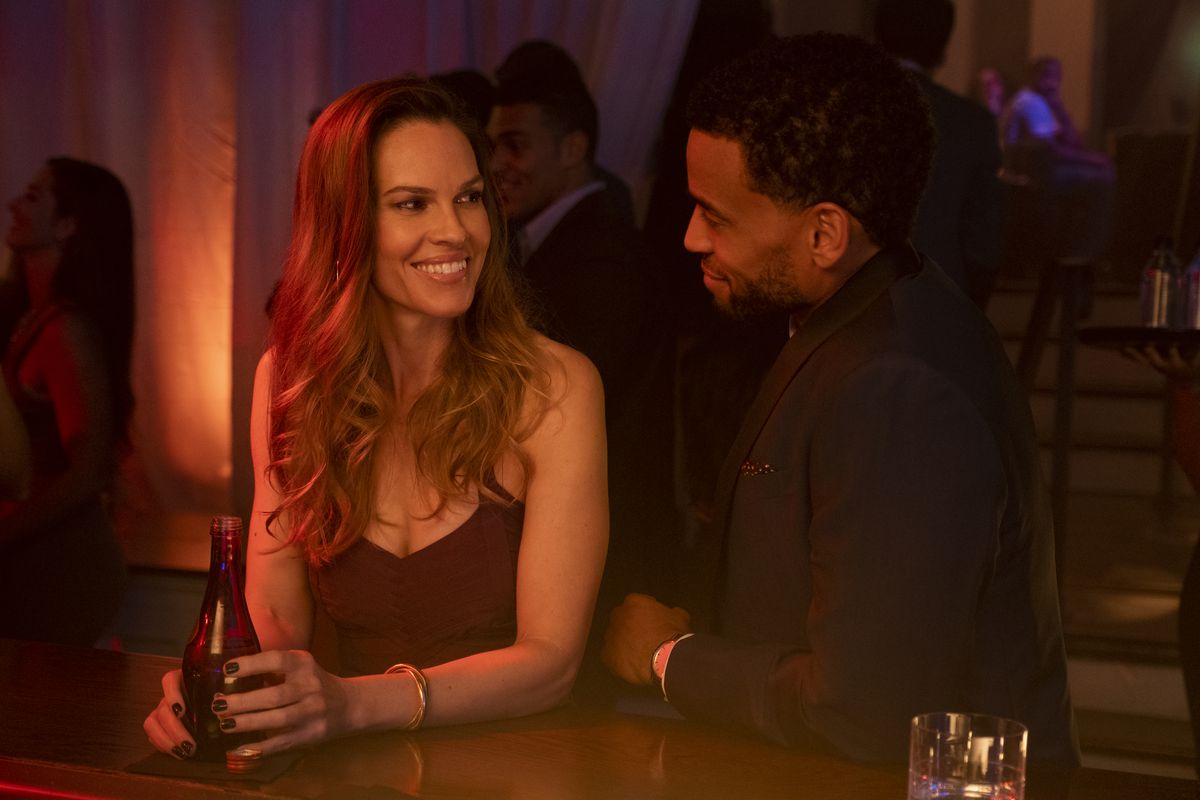Fatale: Hilary Swank smilse at Michael Ealy at a bar