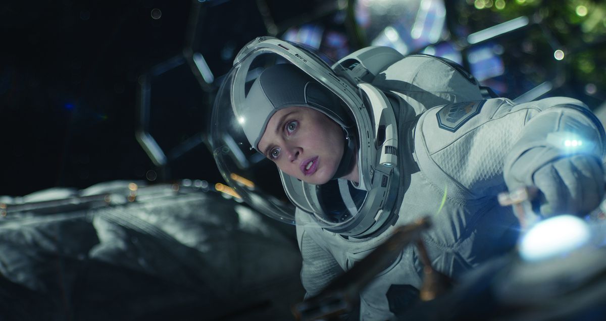 Felicity Jones floats in space in a space suit in The Midnight Sky