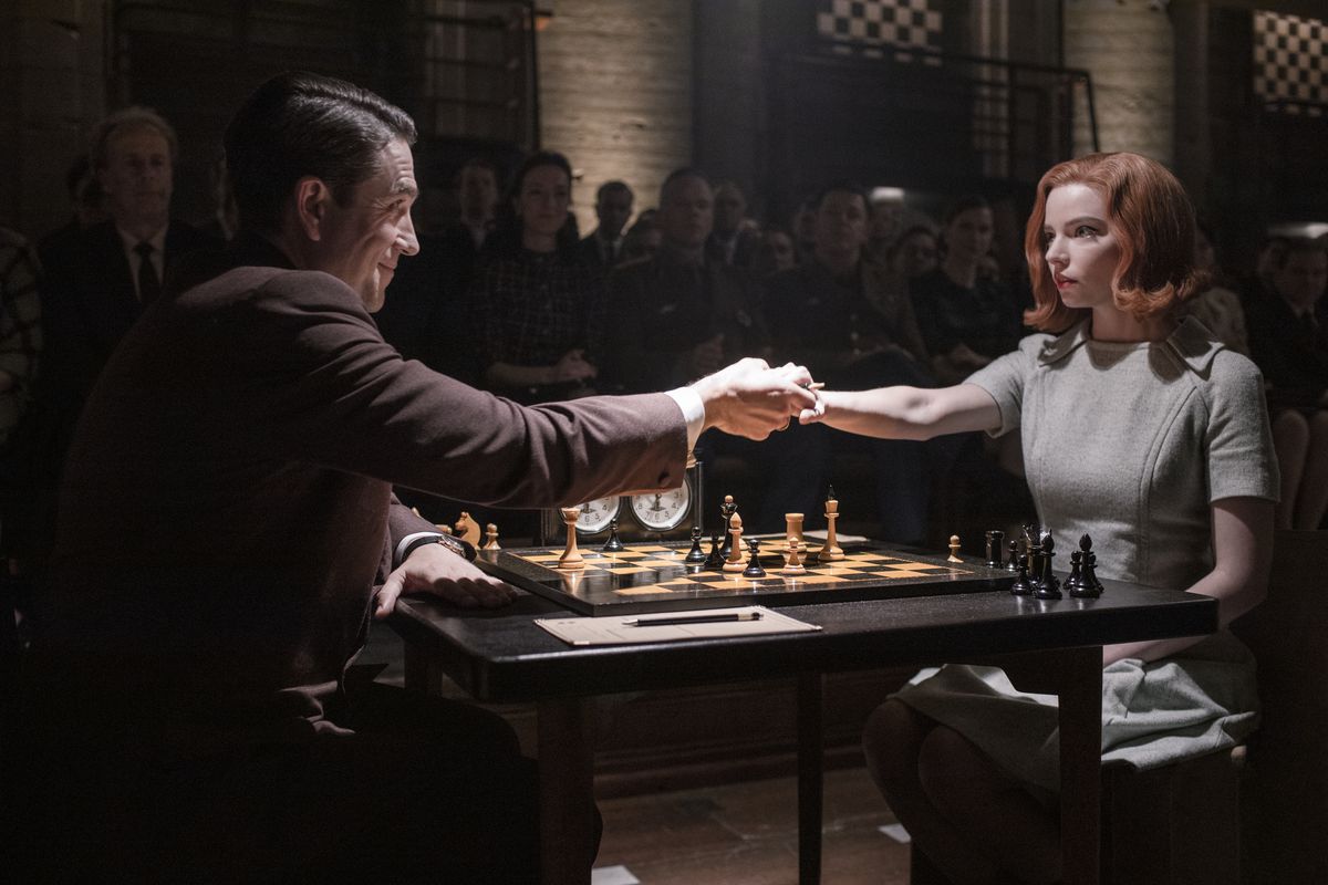 Queen’s Gambit: Anya Taylor-Joy shakes a guy’s hand over a chess board