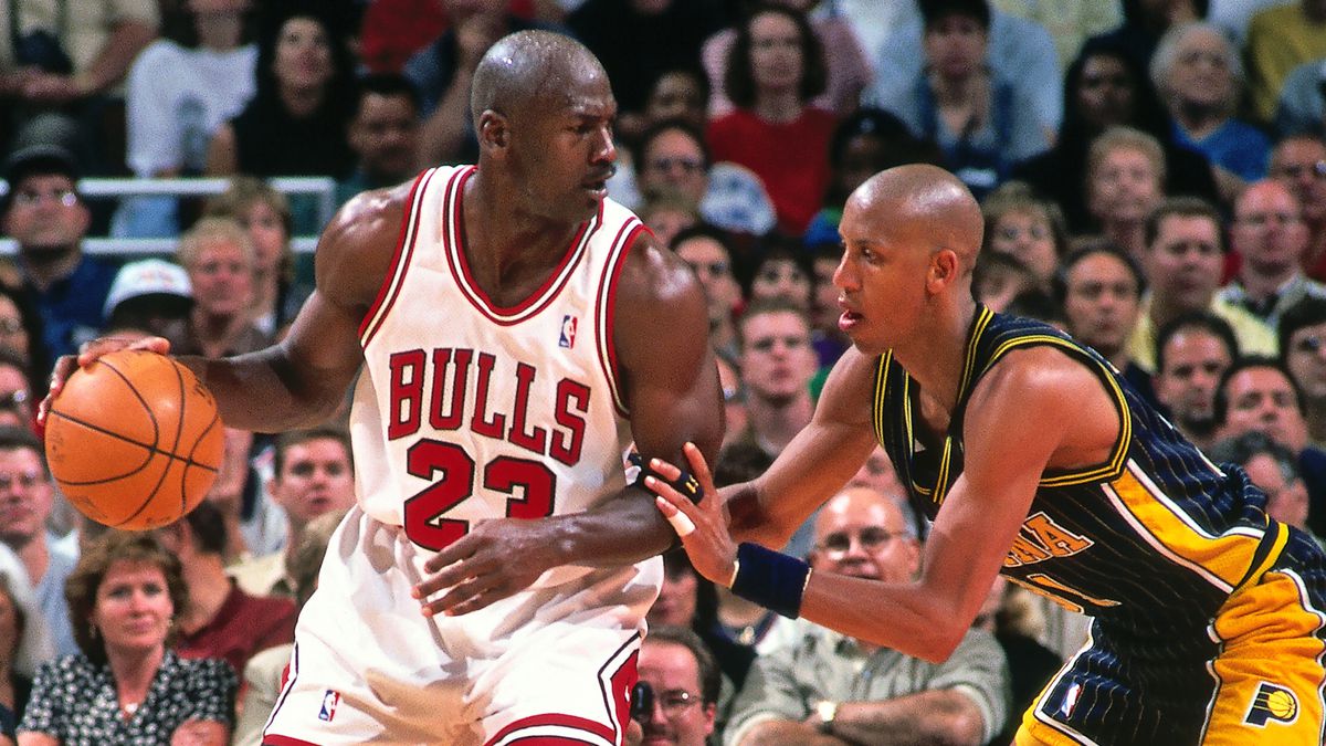 Michael Jordan plays basketball against another basketball player