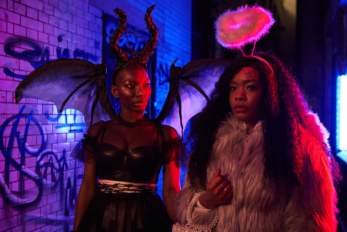 Michaela Coel and Weruche Opia in angel and devil costumes in I May Destroy You