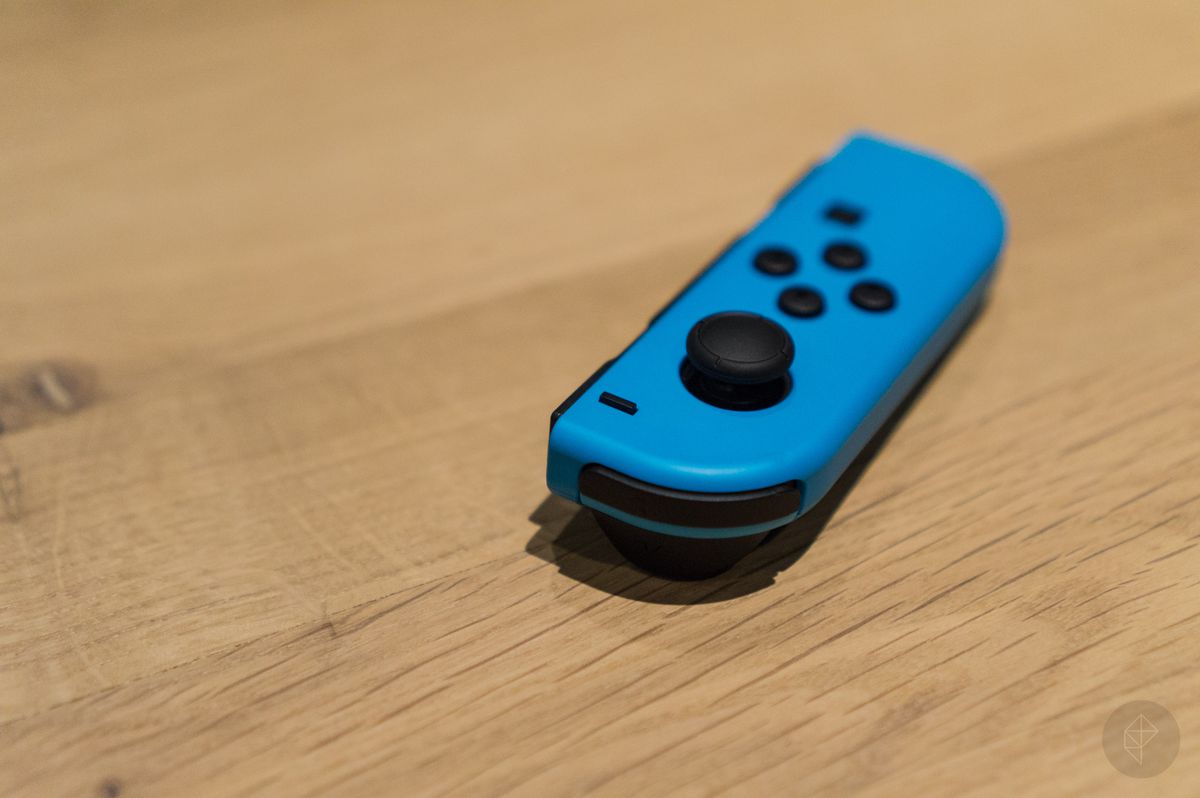 blue left Joy-Con for Nintendo Switch, on a wooden surface