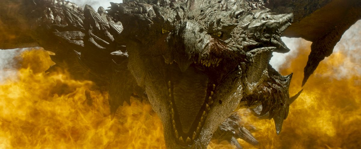 Rathalos, una bestia ruggente di tipo drago, circondata dalle fiamme in Monster Hunter