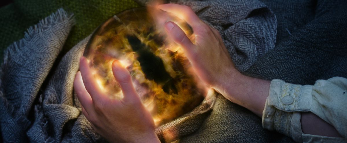 Sauron’s eye ball with Pippin’s hands on it in Lord of the Rings