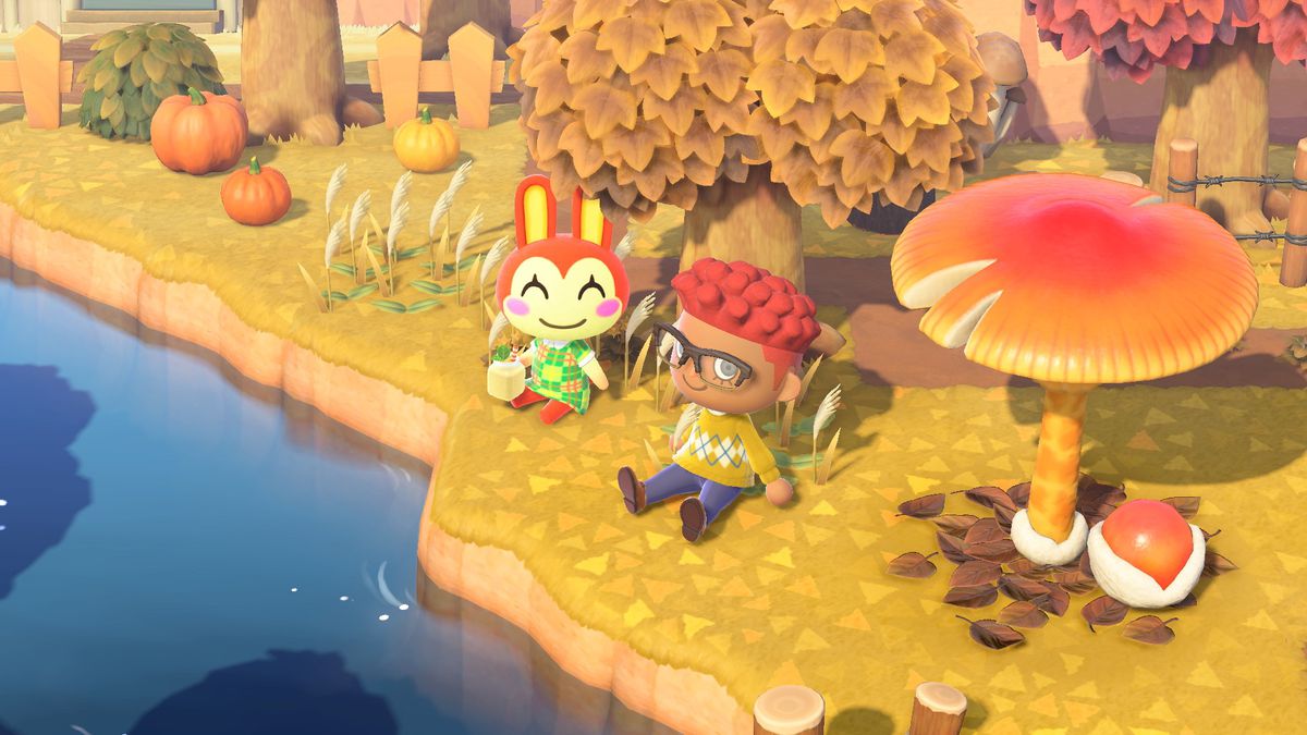 An island resident and bunny sit by a river in a screenshot from Animal Crossing: New Horizons