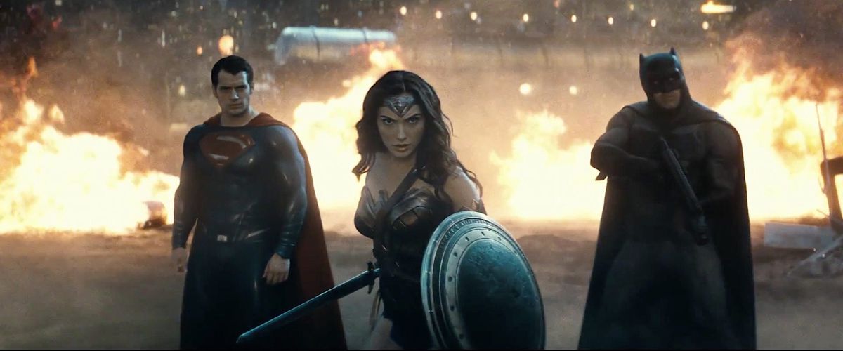 Superman, Wonder Woman, and Batman standing in front of fires together in Batman v. Superman: Dawn of Justice