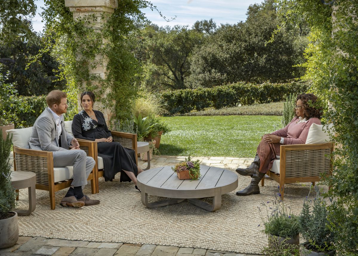 Prince Harry and Meghan Markle sit across from Oprah in a veranda