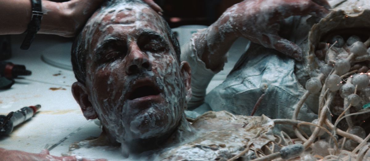A robot’s head decapitated with white goop on its face in Alien