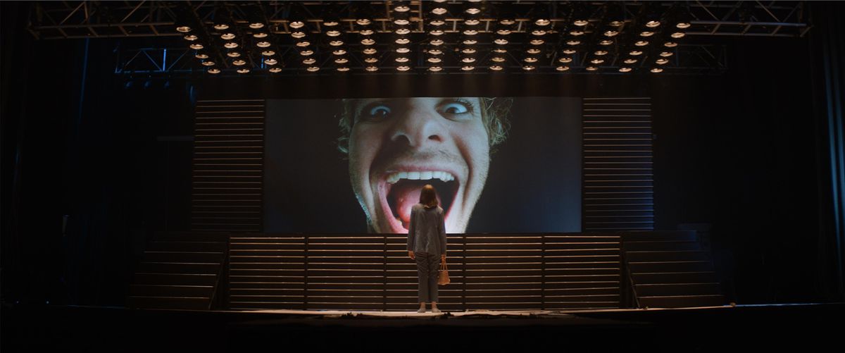 Maya Hawk stares at a giant screen of Andrew Garfield with his mouth agape in Mainstream