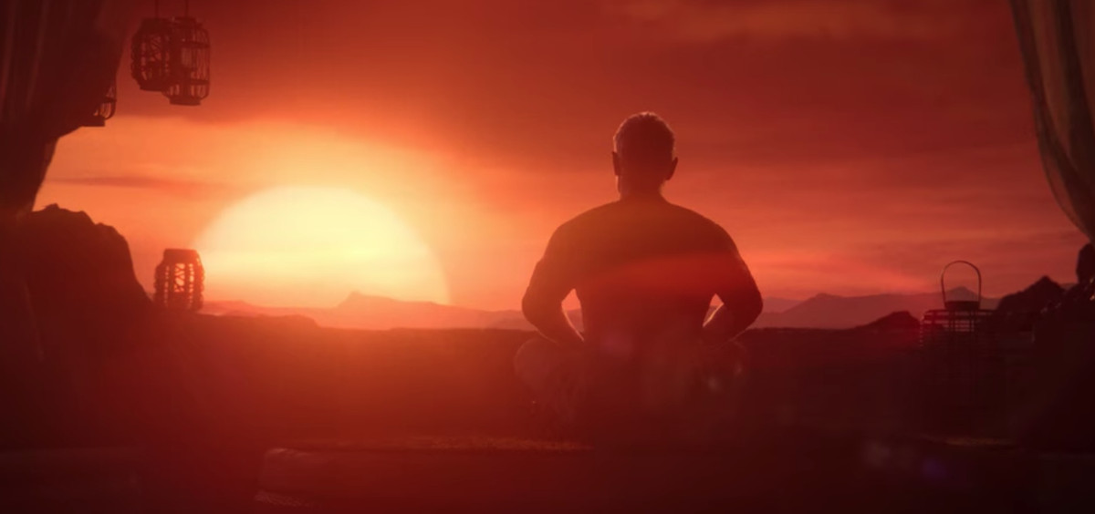 un uomo seduto a gambe incrociate davanti al sole al tramonto 