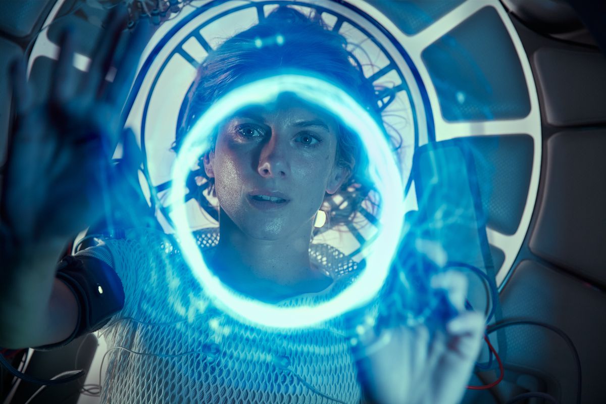 Mélanie Laurent seen through a ring of blue light in her cryo-pod in Oxygen