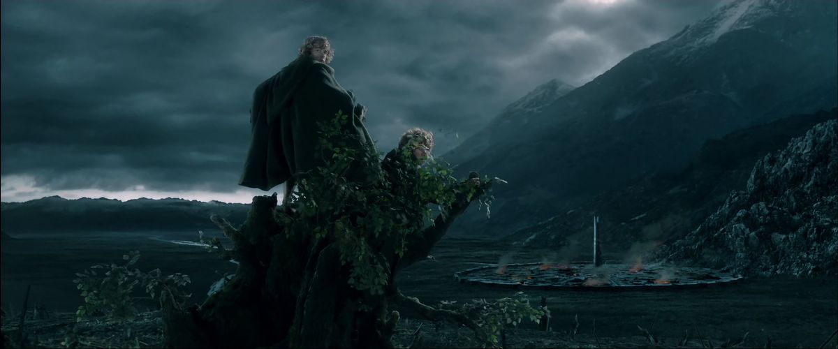 Seduti in cima a Barbalbero, Merry e Pipino osservano i fuochi e il fumo della torre di Orthanc a Isengard nelle Due Torri. 