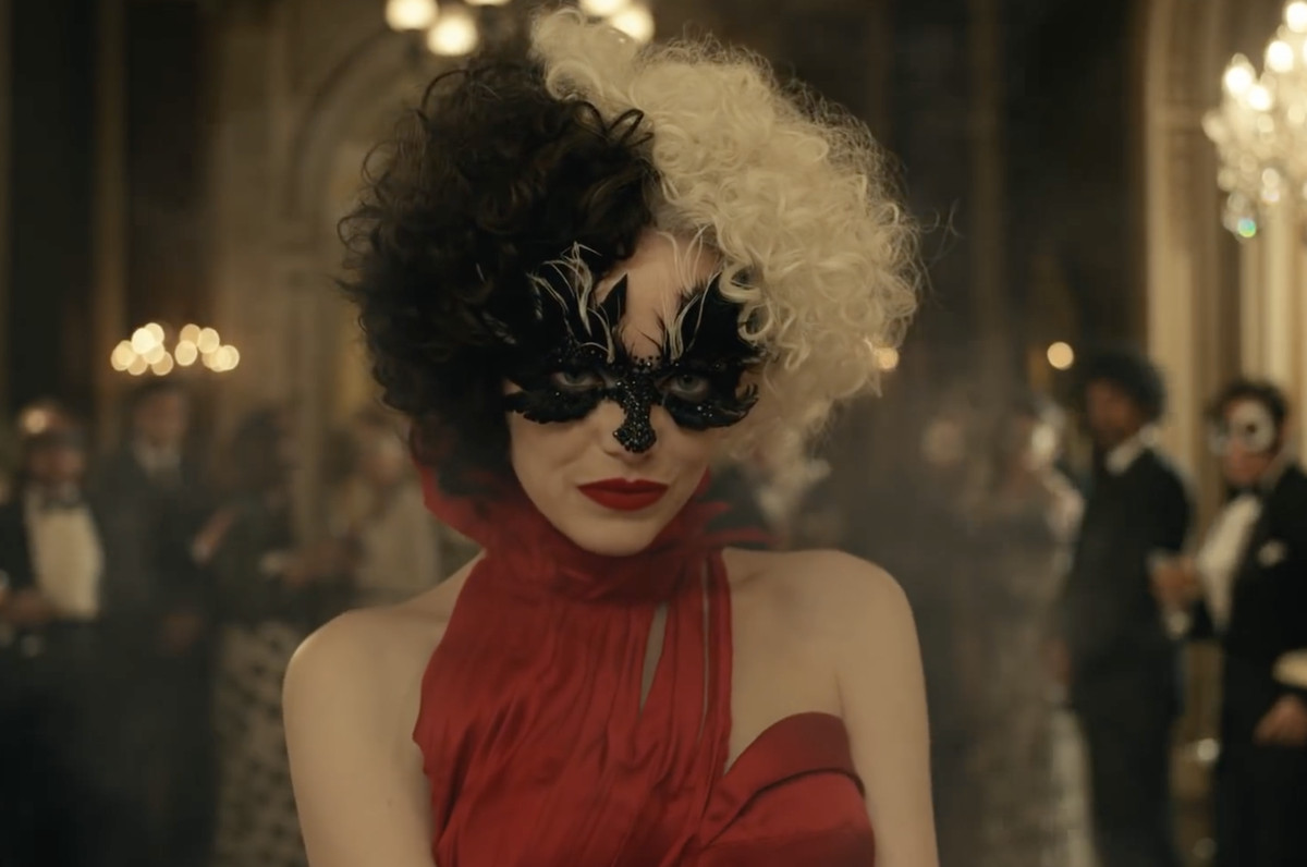 cruella de vil in a fabulous masquerade mask and red gown