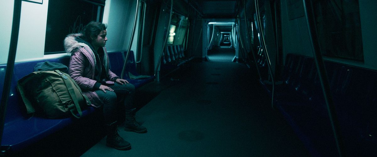 Cristina Rodlo come Ambar siede in un treno della metropolitana che sembra estendersi all'infinito in Nessuno esce vivo