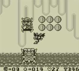 Wario salta verso le monete in uno screenshot del Game Boy