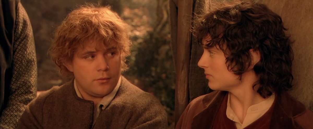 Frodo and Sam exchange a glance during the Council of Elrond in The Fellowship of the Ring.