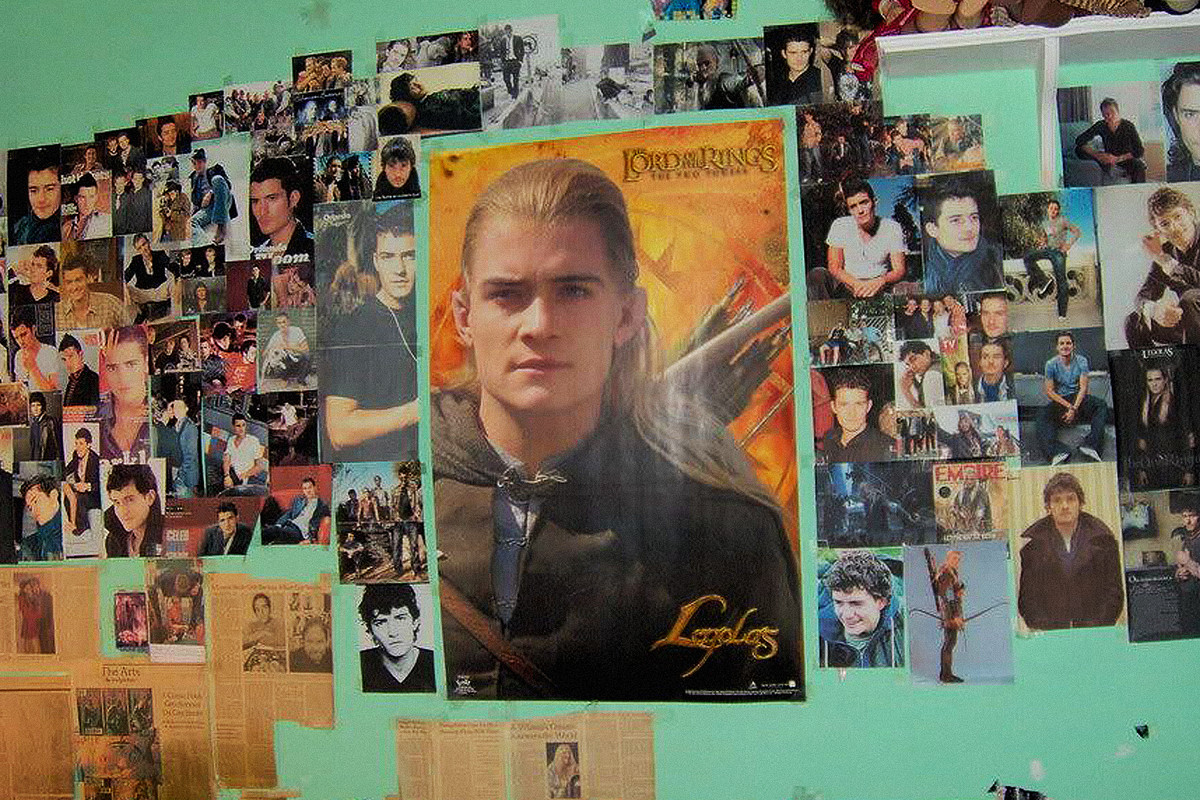 Photo of a bedroom wall featuring images and press clippings of Legolas from The Lord of the Rings movie.